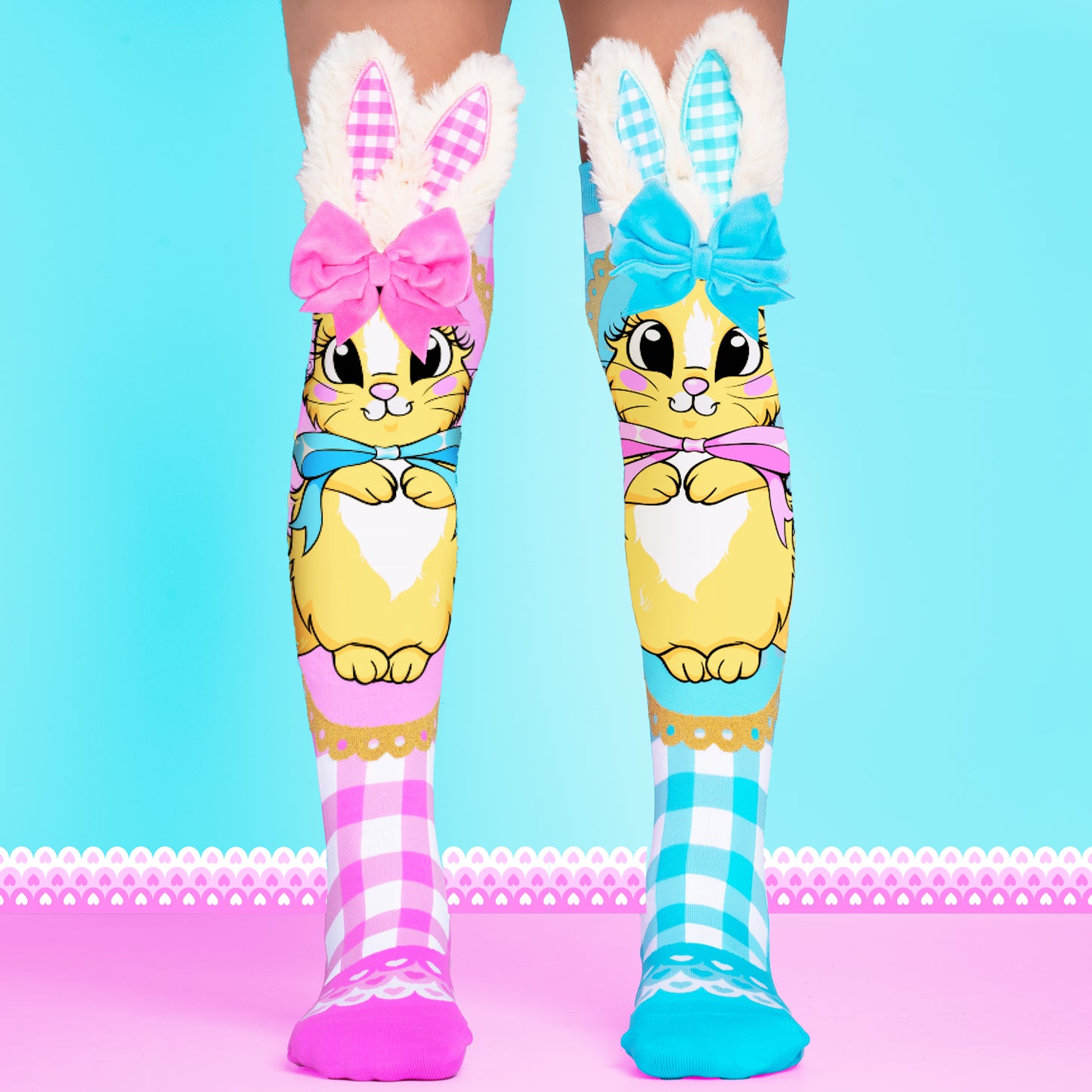 Bunny socks with soft fuzzy ears and velvet bows in pink and blue.