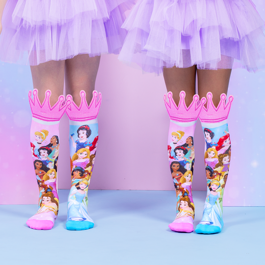 MADMIA Disney Princess themed knee-high socks featuring pink crown toppers and various princess characters worn with purple tutus.