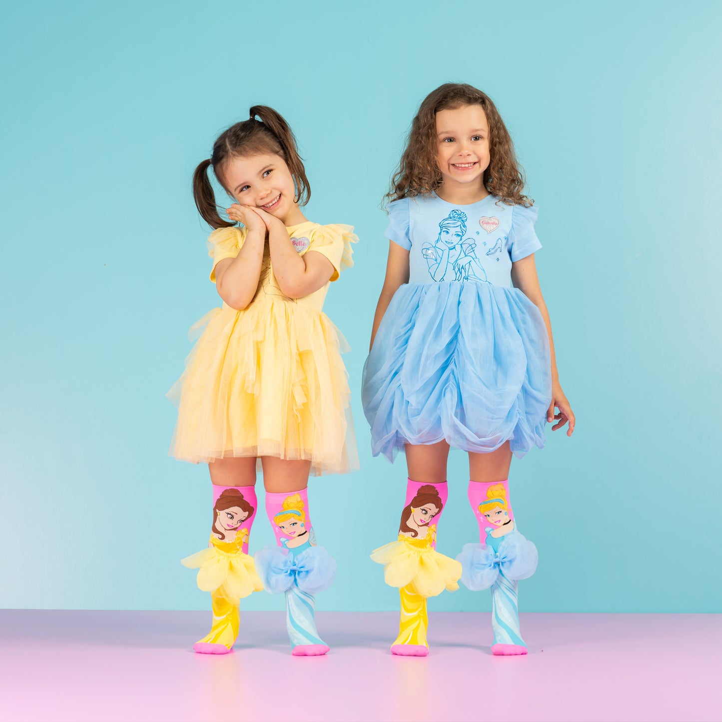 Belle and Cinderella character socks with 3D layered skirt and bow details in bright princess design.