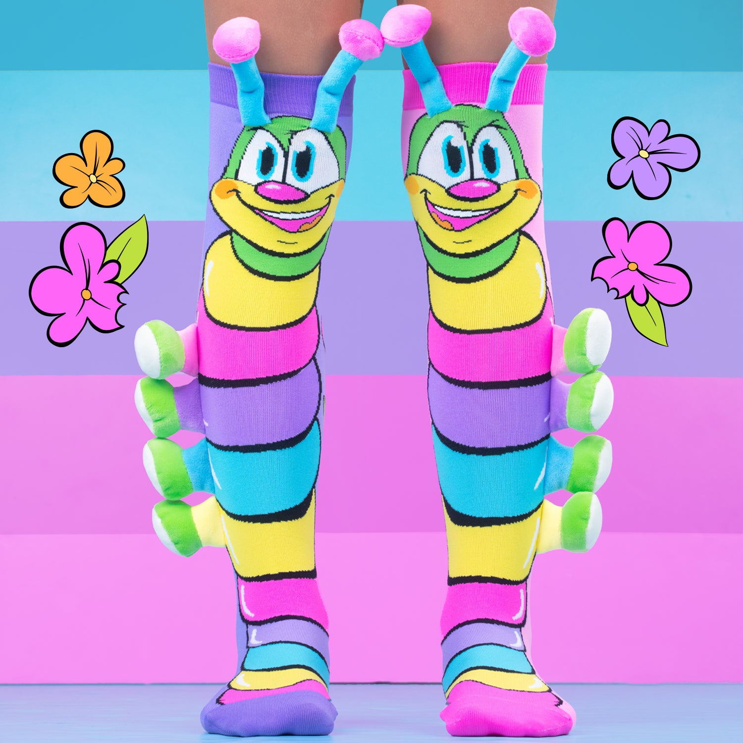 Colorful caterpillar socks close up showing bright design and soft plush legs detail.