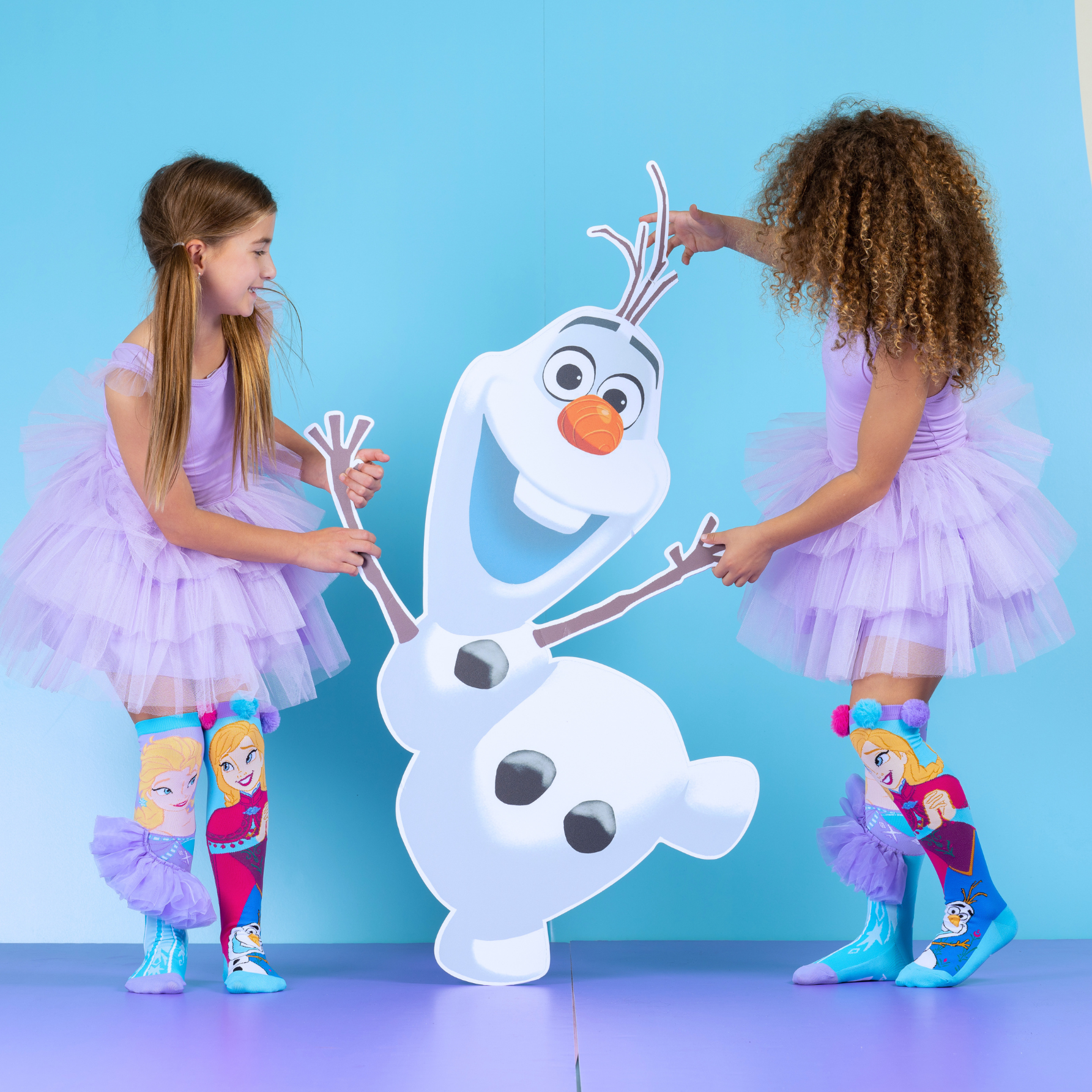 Colorful Disney Frozen character socks featuring Elsa, Anna, and Olaf with playful 3D details.