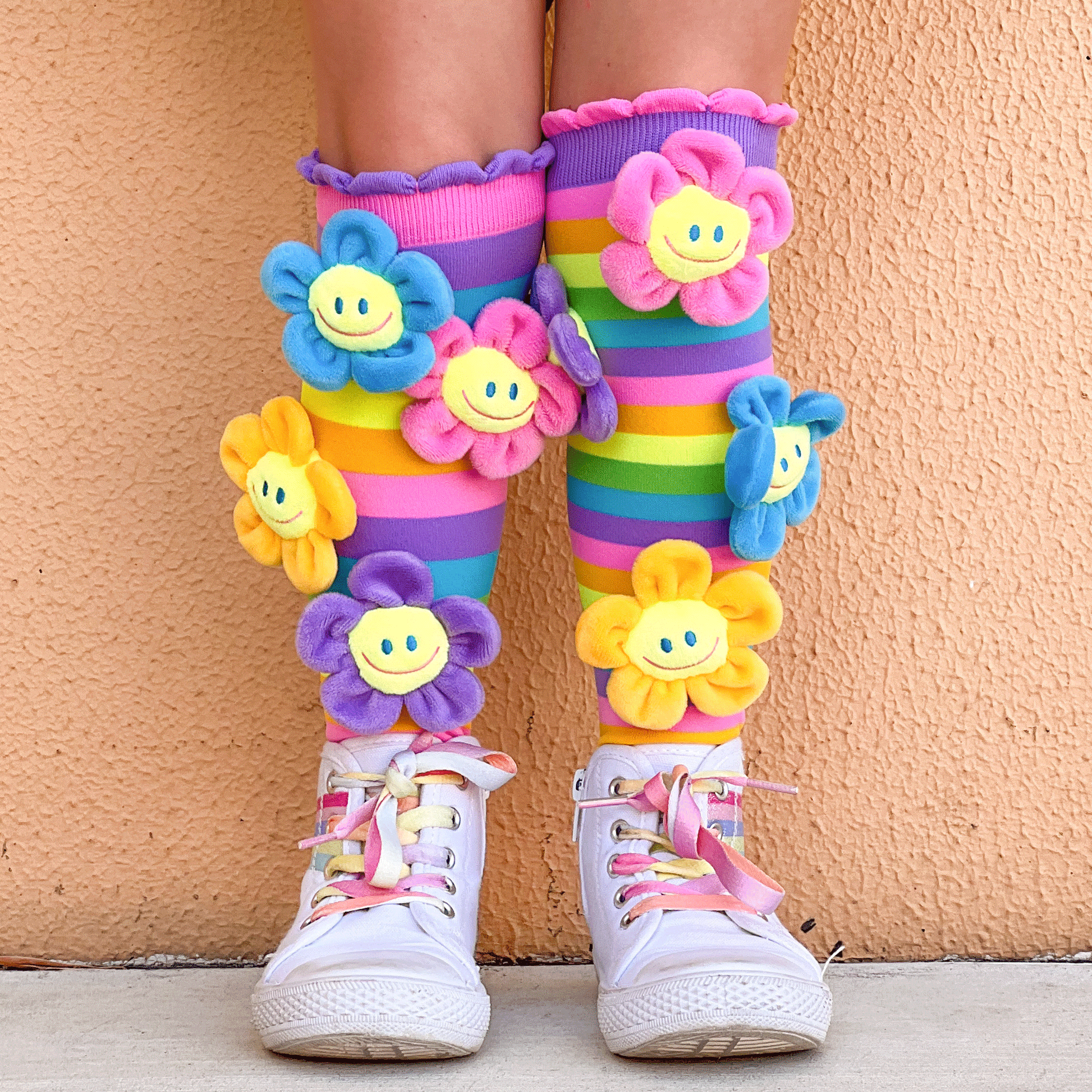 Colorful flower novelty socks with bright spring-inspired colors and plush flower accents.