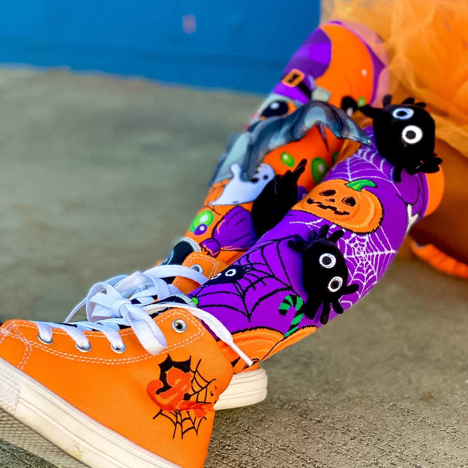 Colorful Halloween socks with attached 3D bat wings and plush spider accents.