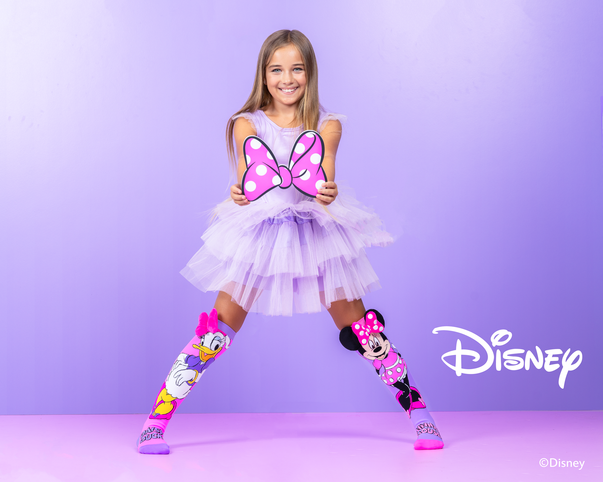 Colorful Minnie and Daisy novelty socks for kids and adults with custom plush bows and playful Disney design.