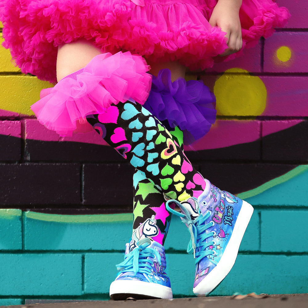 Colorful novelty socks with bold bright colors and playful fashion-inspired frill details.
