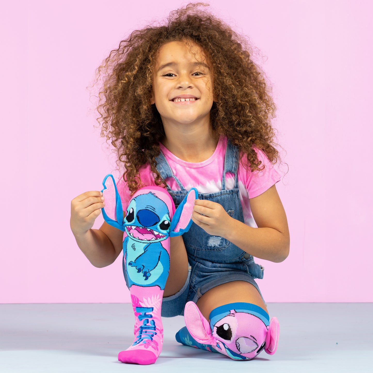 Colorful Stitch and Angel knee high socks for kids with fun design and attached plush ears.