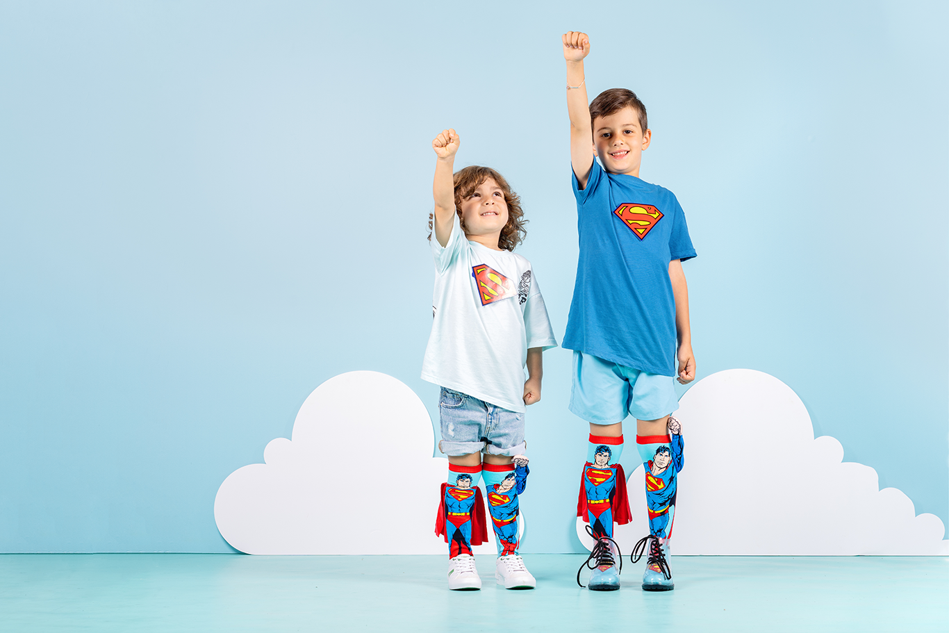 Colorful Superman character socks with plush arm detail, velvet cape, and comic book style.