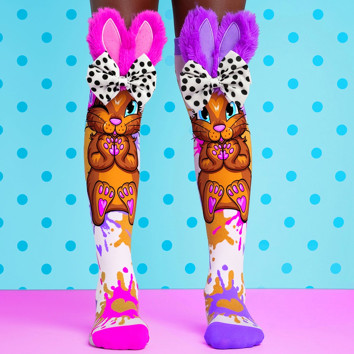 Cute Easter bunny knee high socks featuring plush ears, polka dot bows and colorful paint splash artwork.