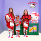 Girls wearing Hello Kitty knee high socks with colorful character graphics and plush bows
