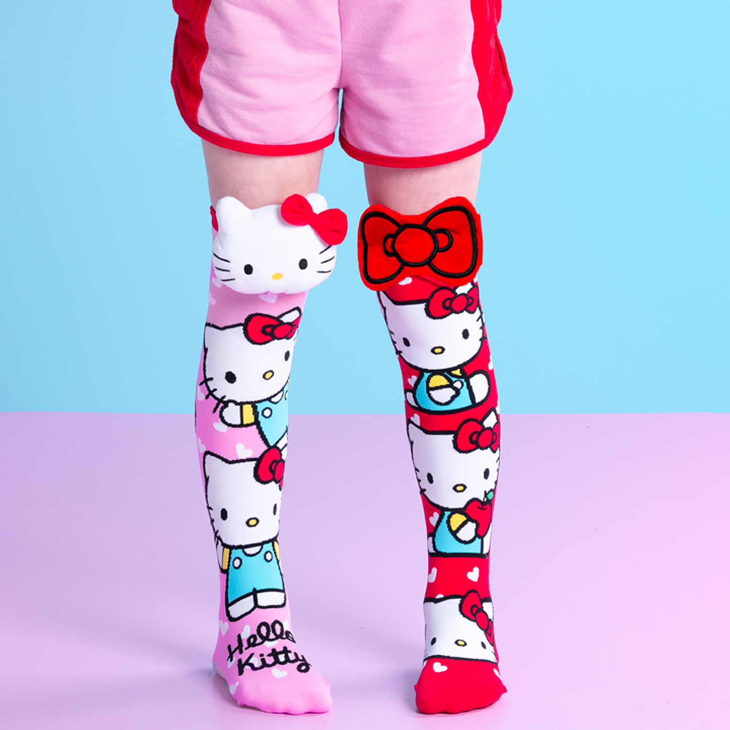 Hello Kitty themed socks with pink hearts and plush 3D accents