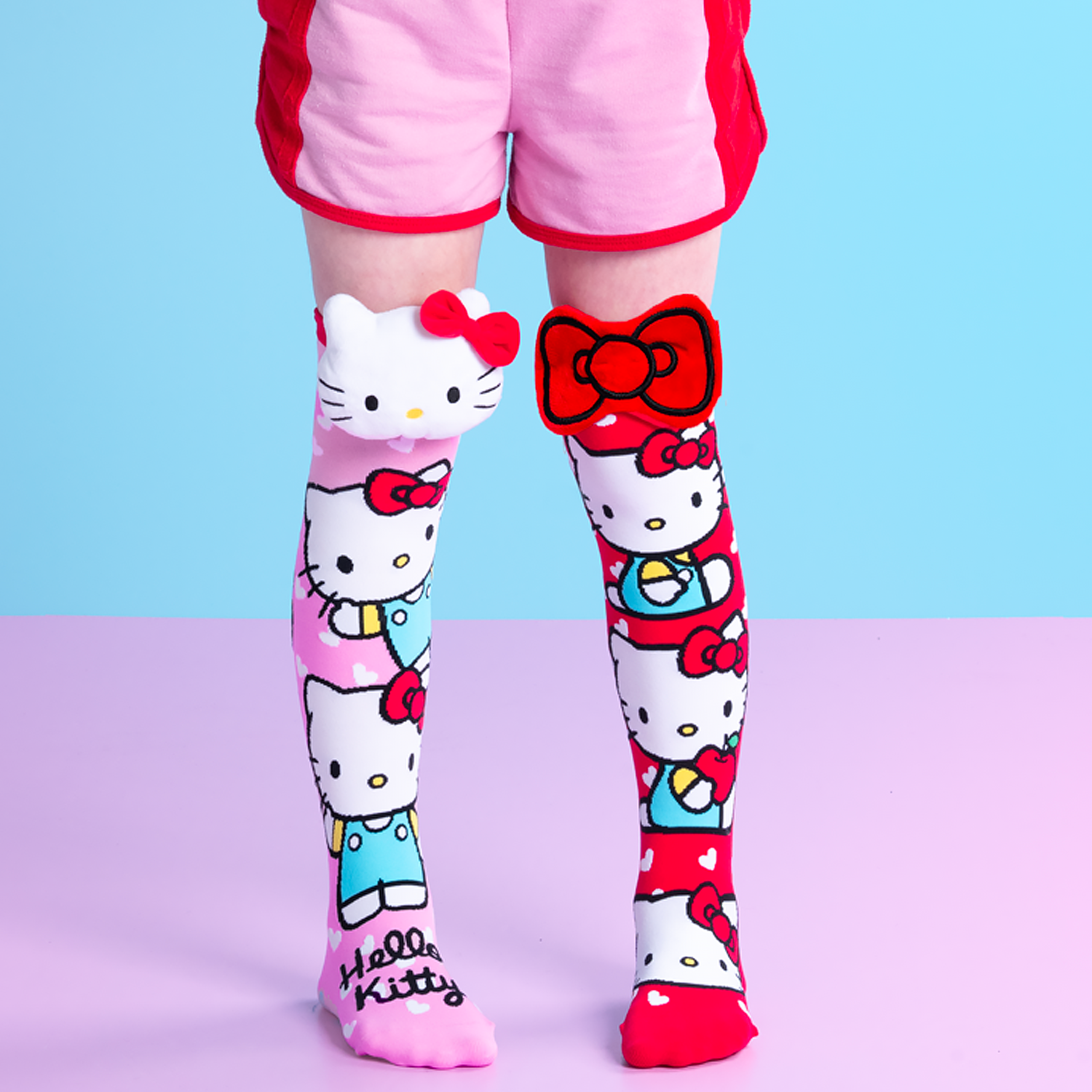 Hello Kitty themed socks with pink hearts and plush 3D accents