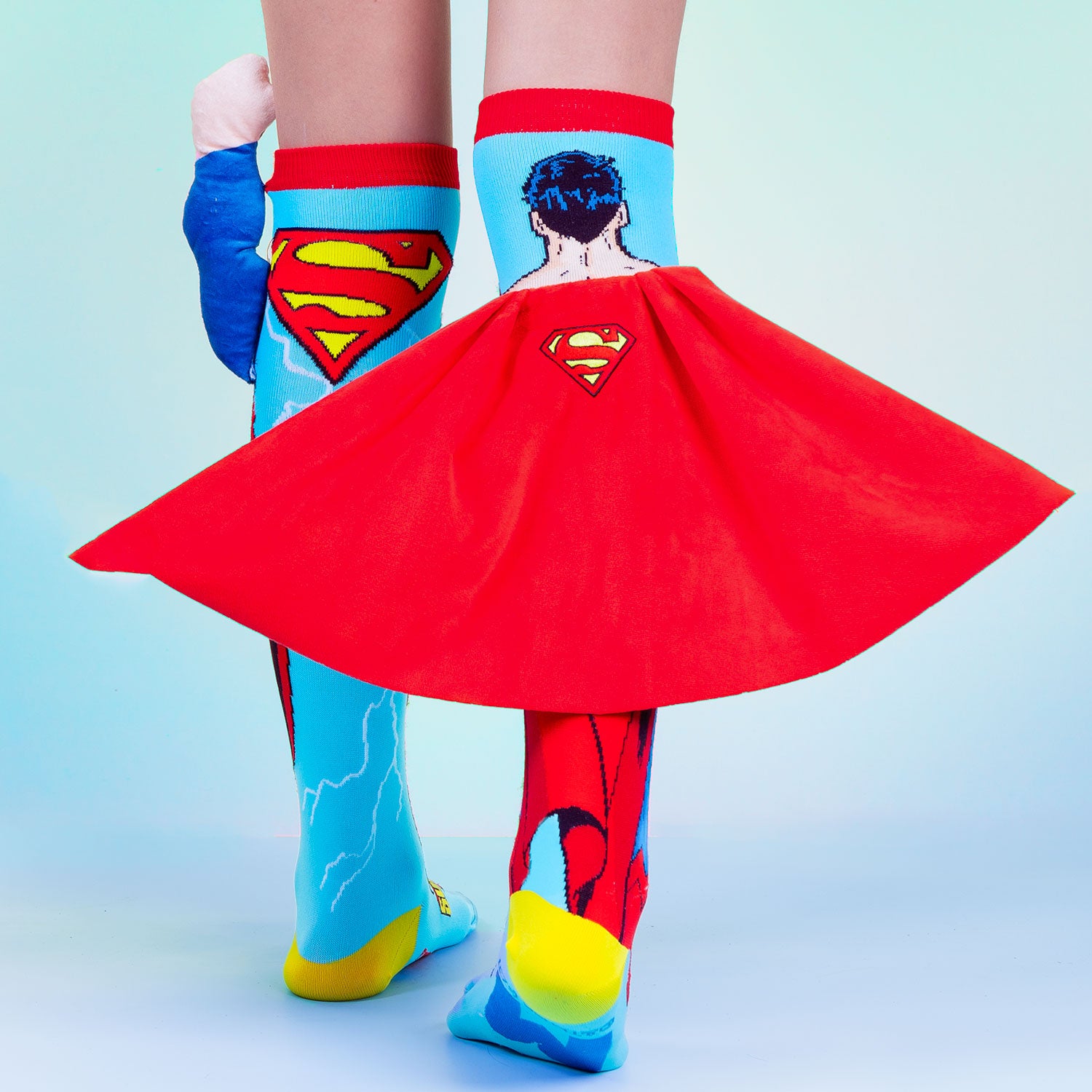 DC Superman superhero socks with embroidered logo, velvet cape, and colorful comic-inspired graphics.