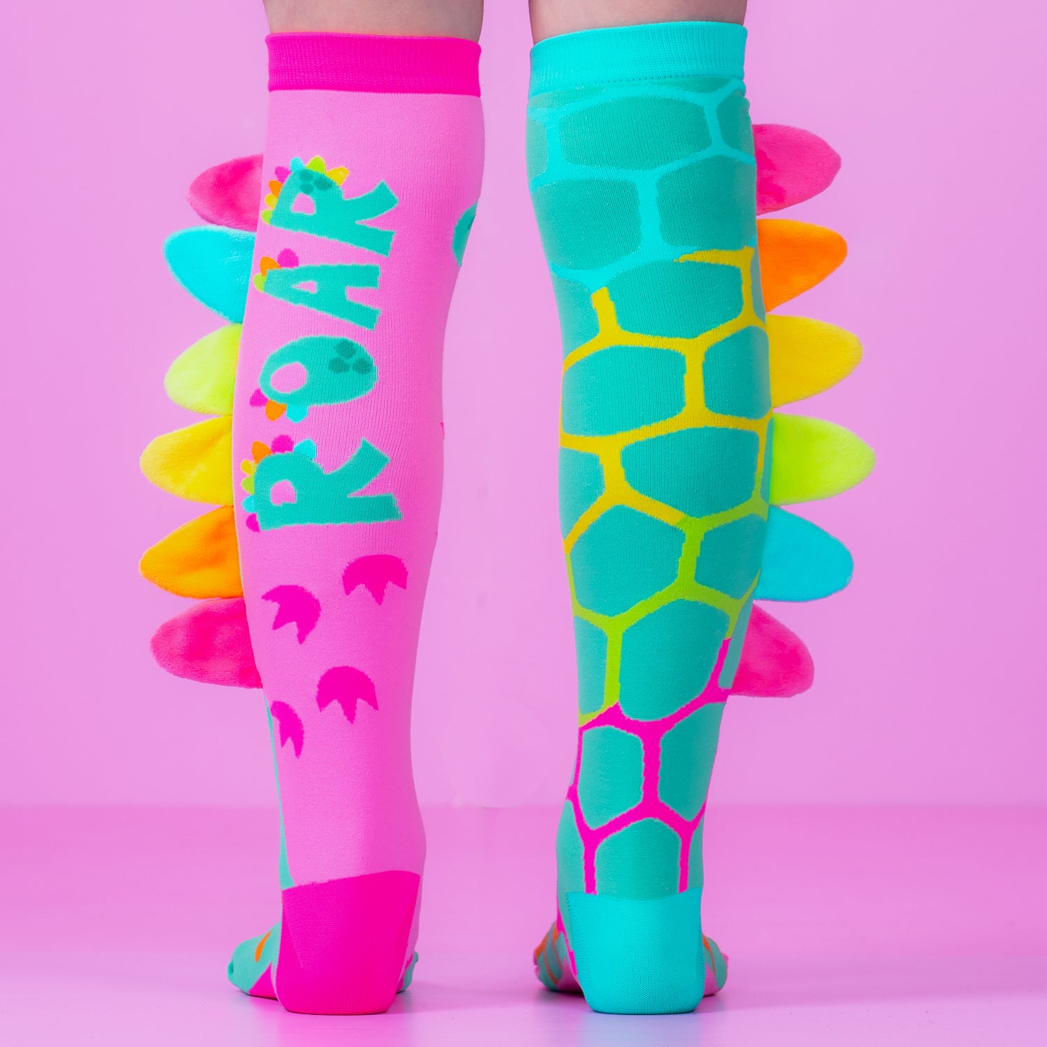 Colorful dinosaur knee high socks for kids and adults with vibrant patterns and plush spikes design.