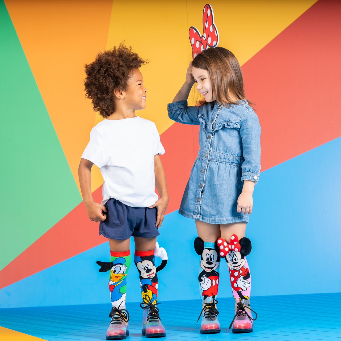 Disney character socks with Mickey Mouse and Donald Duck in bright colorful cartoon style.