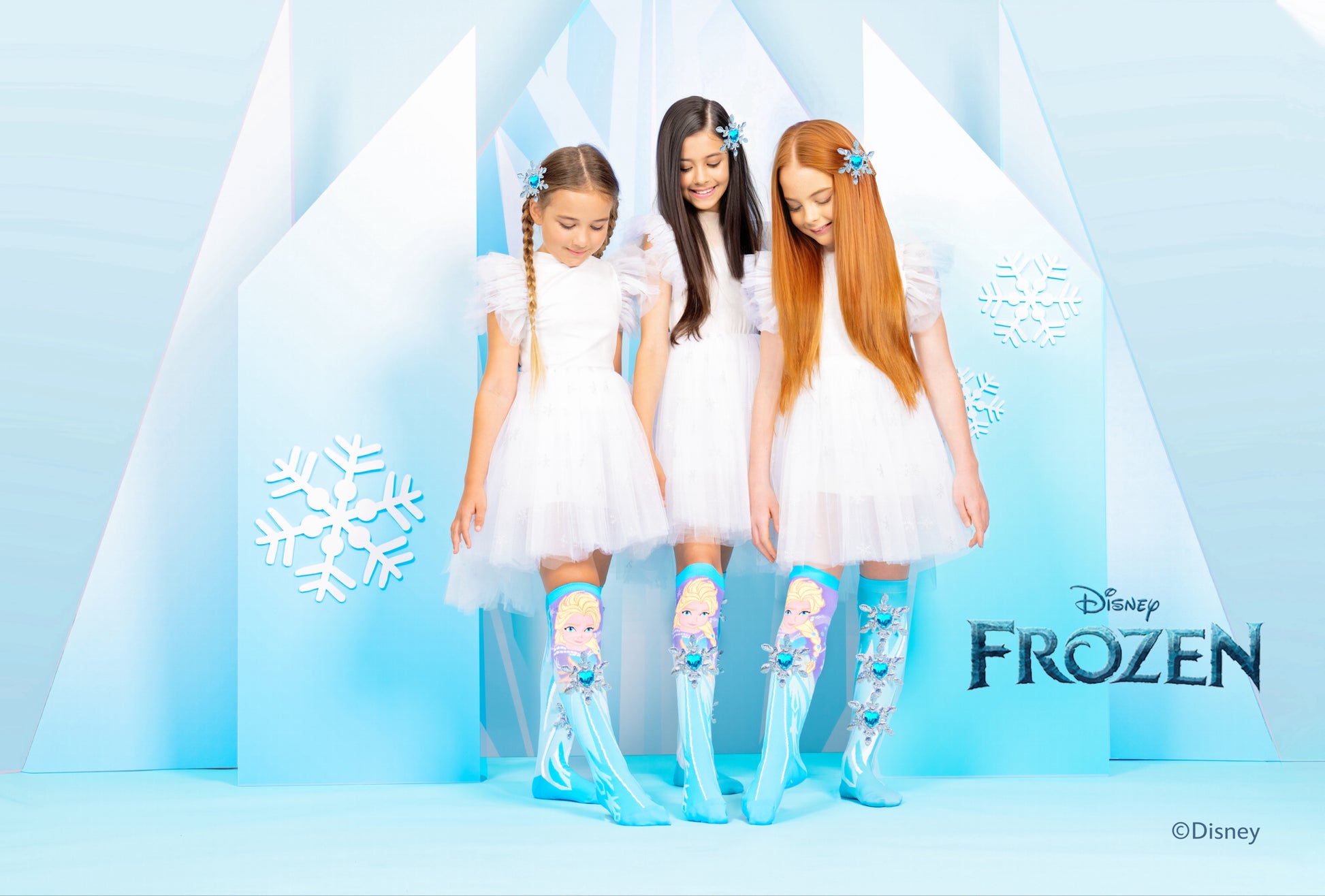 Disney Elsa knee high socks featuring attached sparkly snowflakes and bright Frozen-inspired graphics.