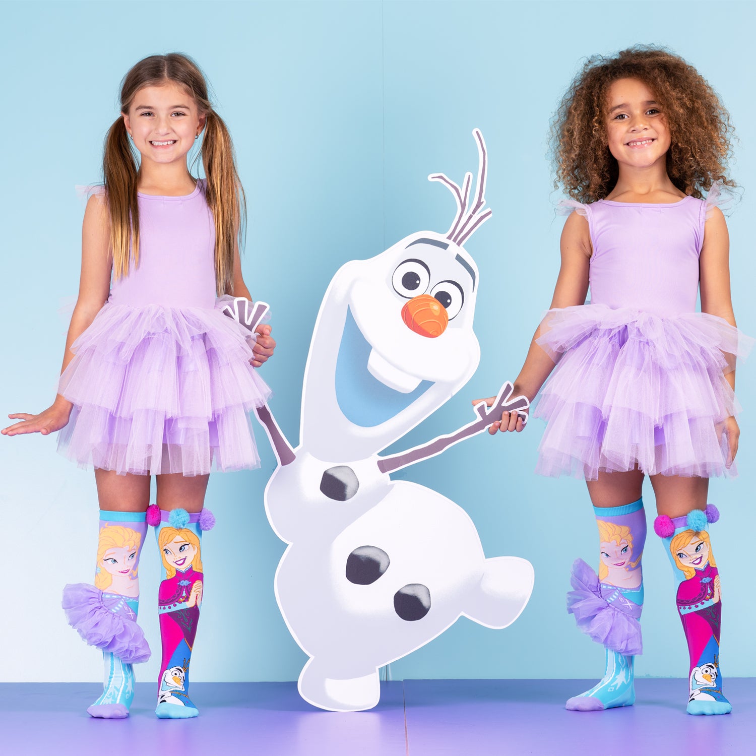 Disney Frozen socks featuring Olaf, playful pom poms, and colorful character design.