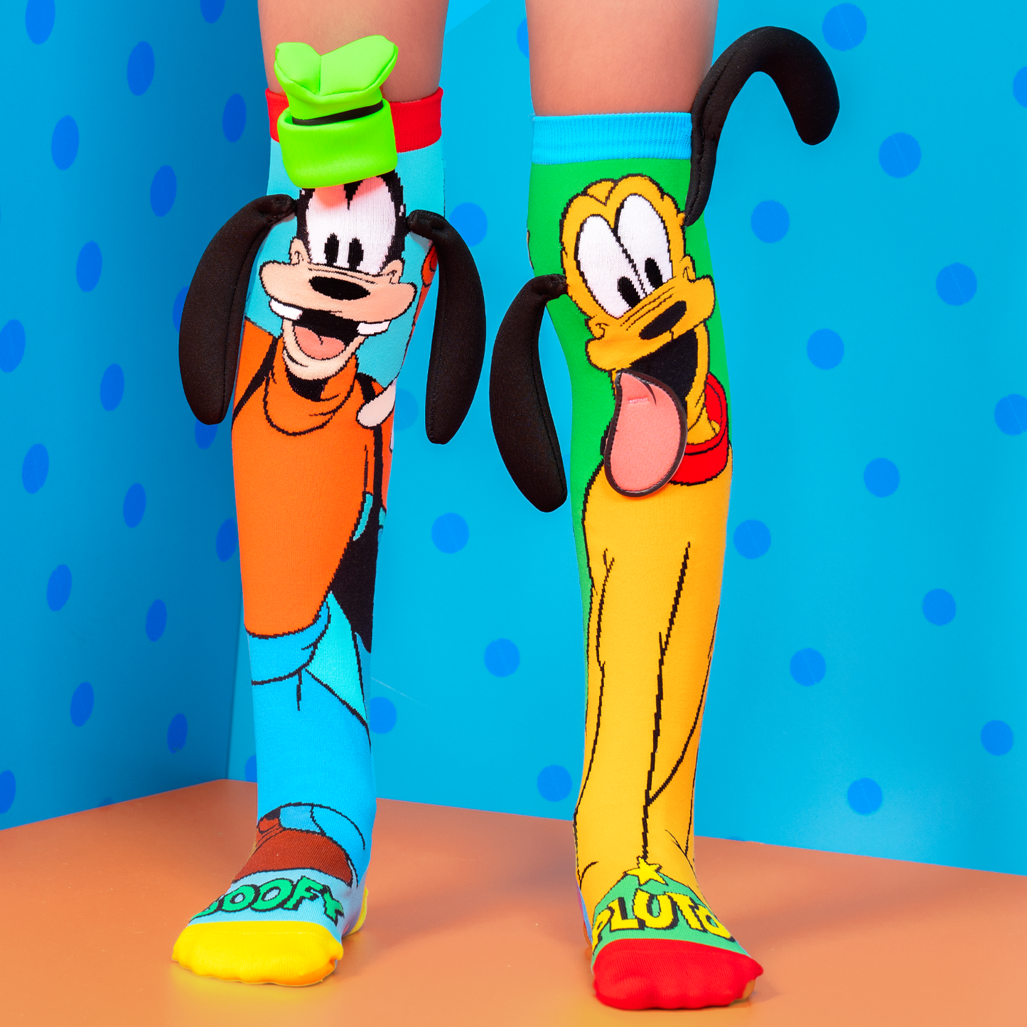 Disney Goofy socks featuring iconic green hat and playful bouncy ears in colorful design.