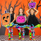 Three girls wearing colorful Jack Skellington Halloween knee high socks with spooky character designs.