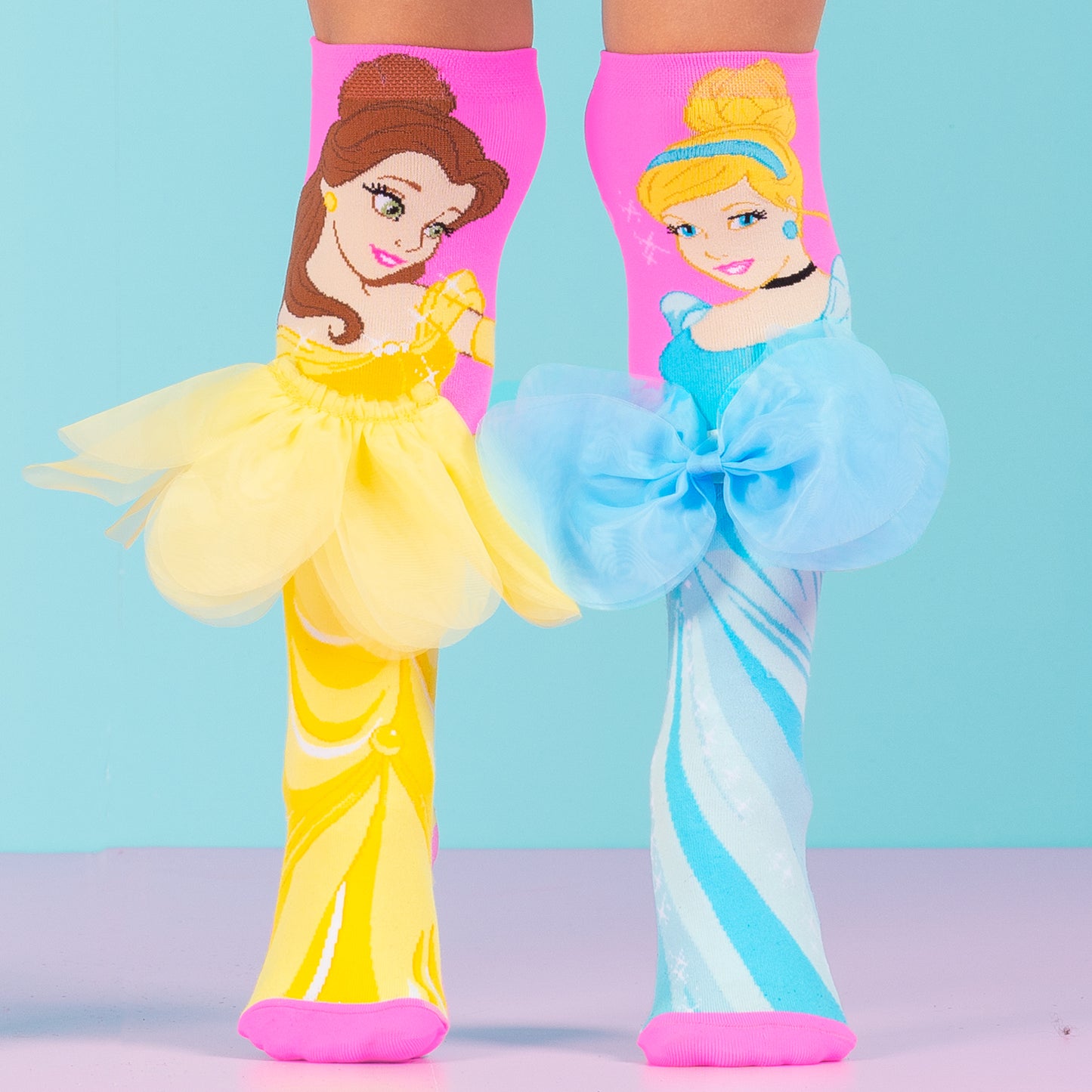 Disney Princess socks featuring Belle with layered skirt and Cinderella with bow in colorful design.