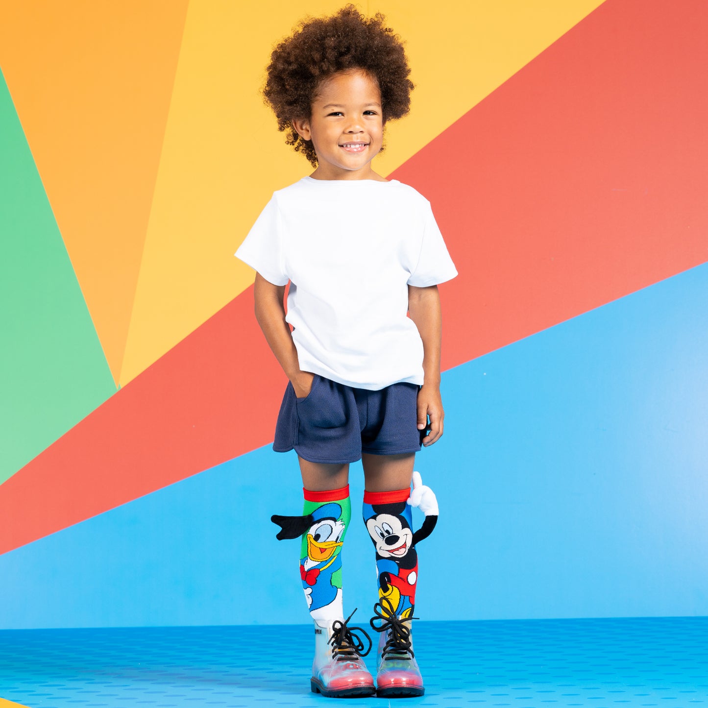 Disney socks featuring Donald Duck sailor hat and plush Mickey hand with colorful design.