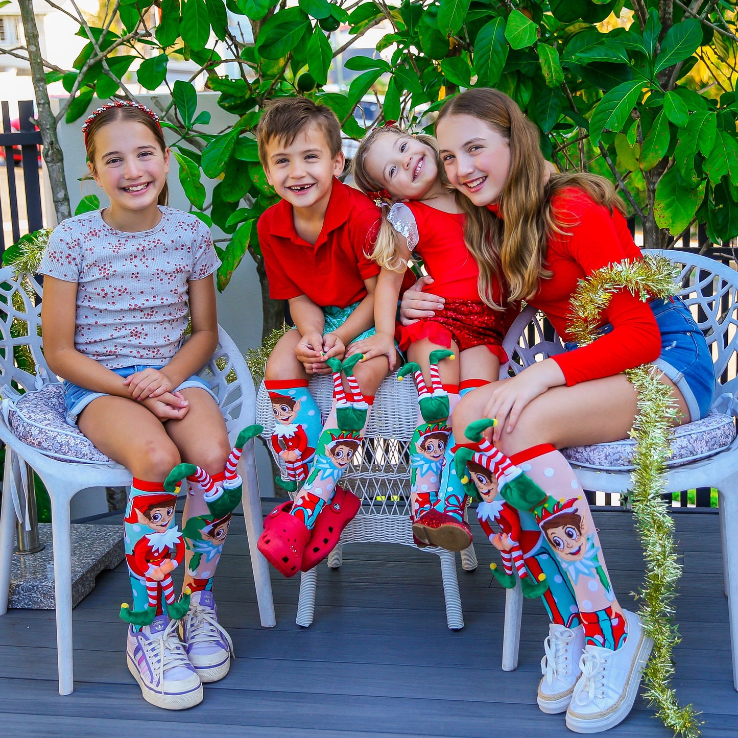 Festive elf socks for kids and adults featuring playful Christmas design and plush elf characters.