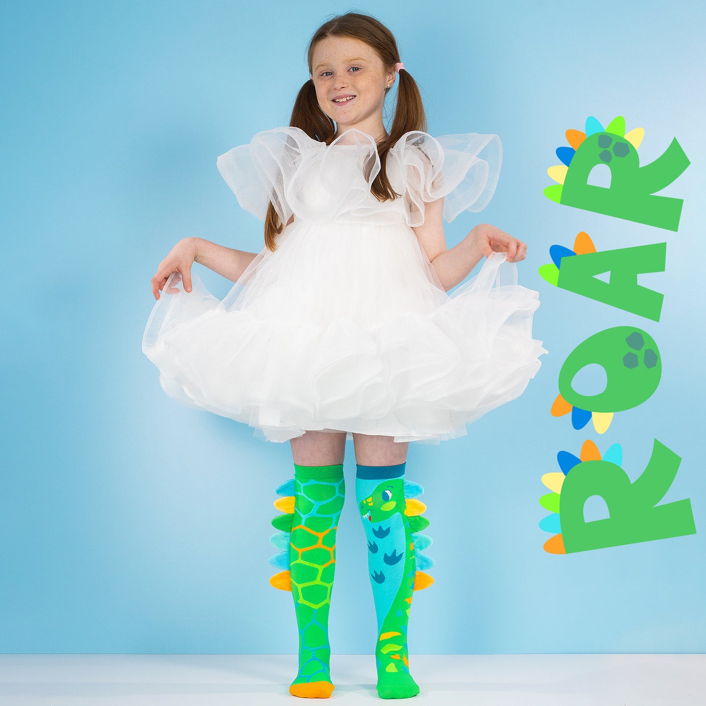 Bright dinosaur themed socks for children with plush spikes along the sides
