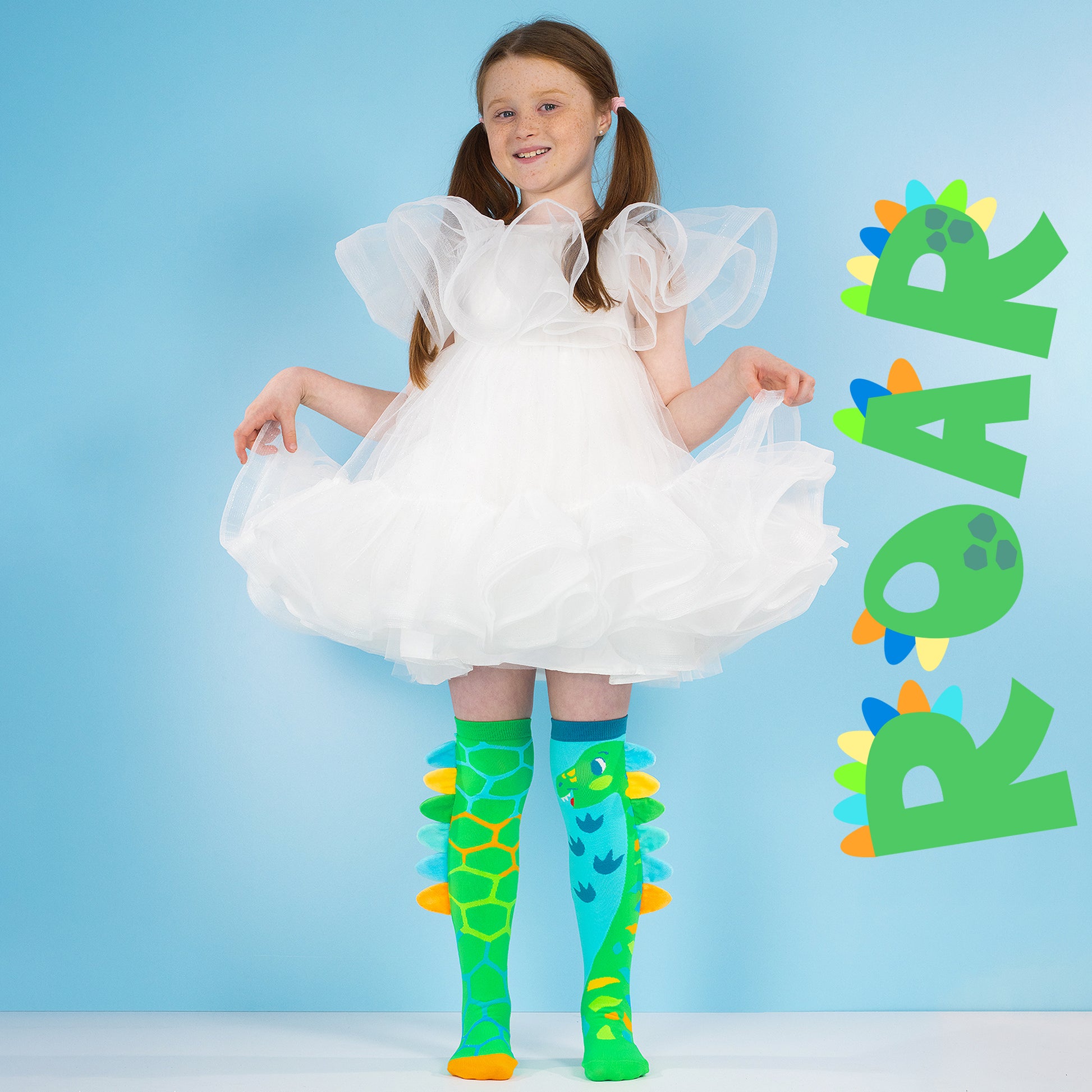 Bright dinosaur themed socks for children with plush spikes along the sides
