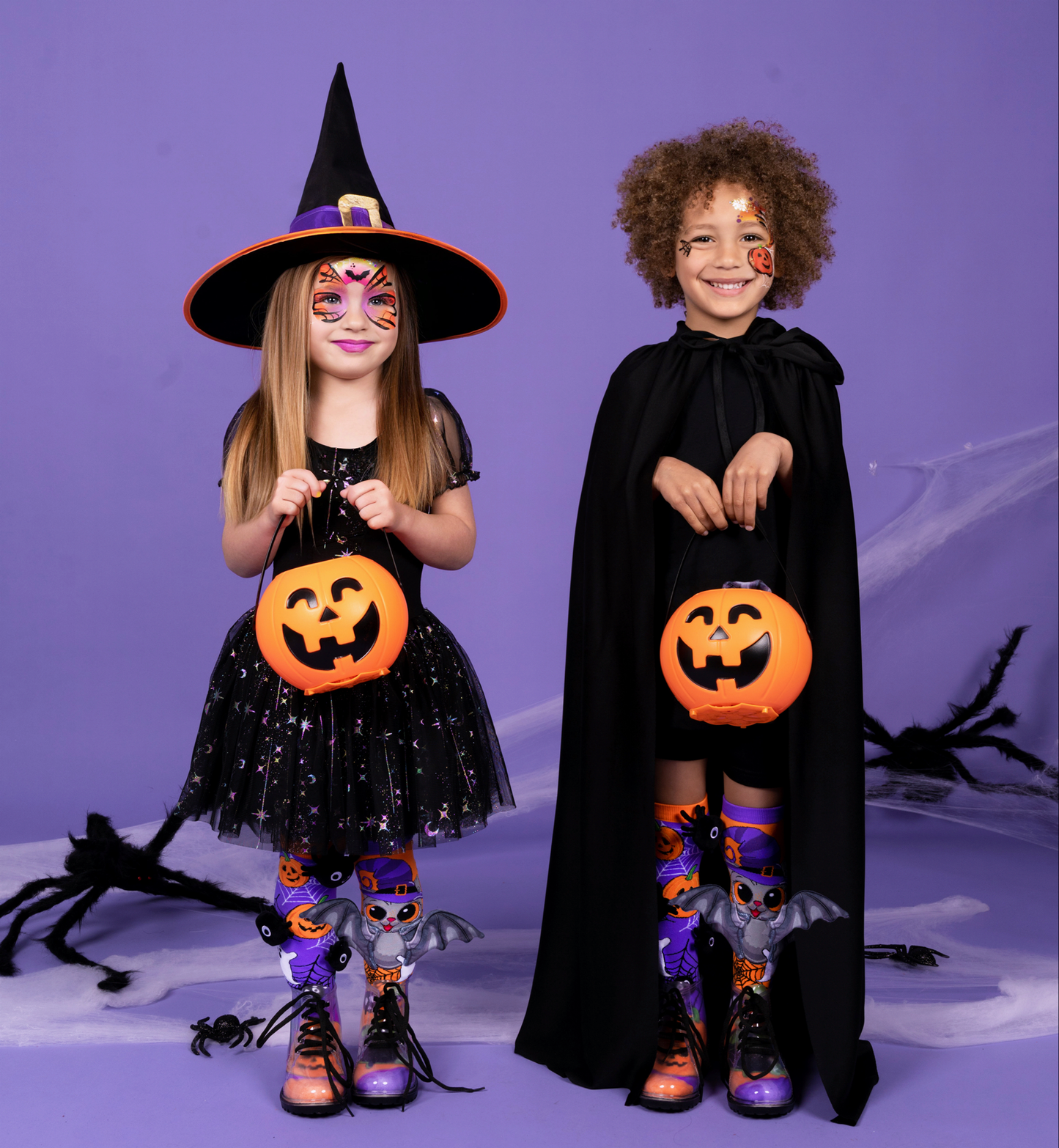 Halloween socks with attached plush spiders and bat wings for a fun trick-or-treat inspired look.