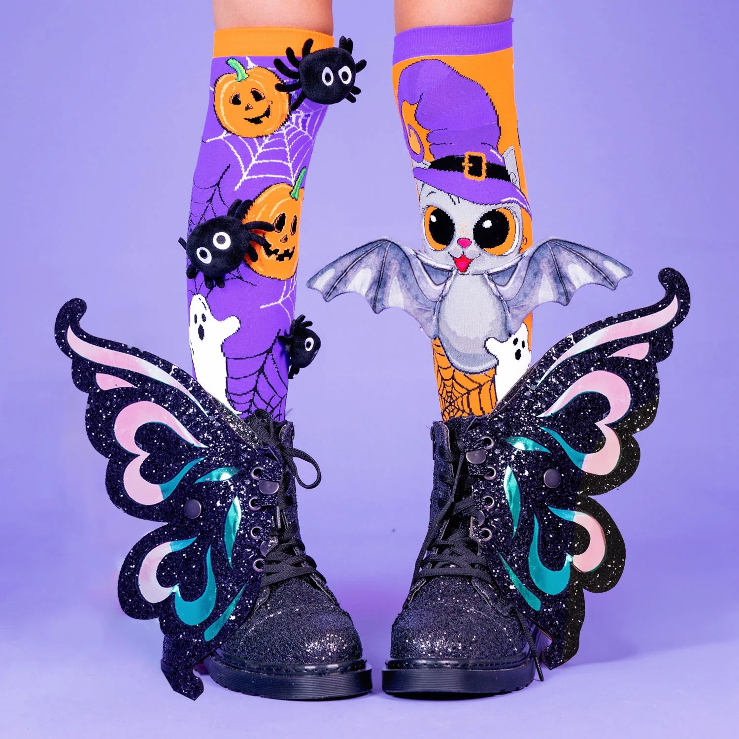 Halloween knee high socks featuring custom 3D plush spiders and attached bat wings in spooky design.