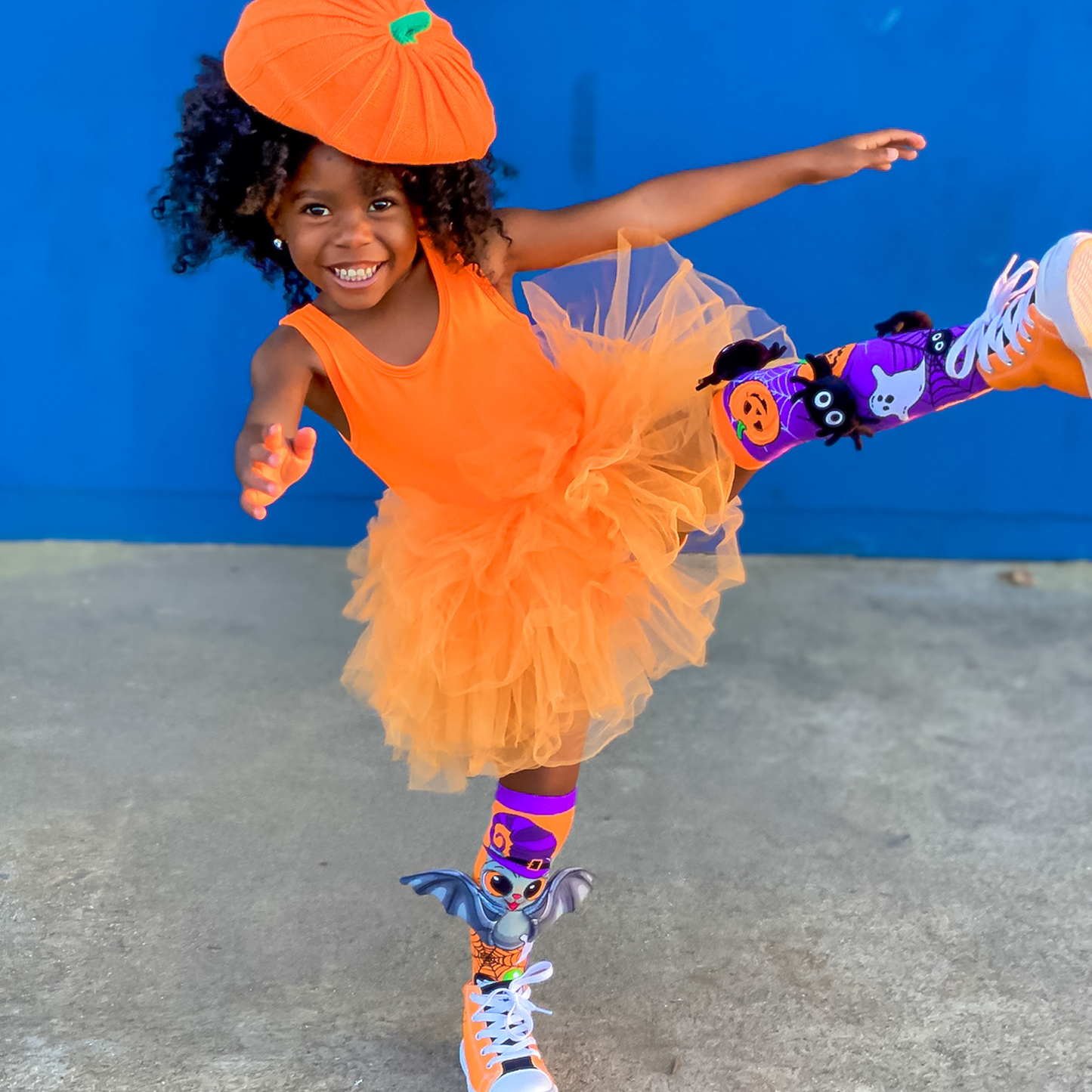 Halloween novelty socks featuring attached plush spiders and playful bat wing details.
