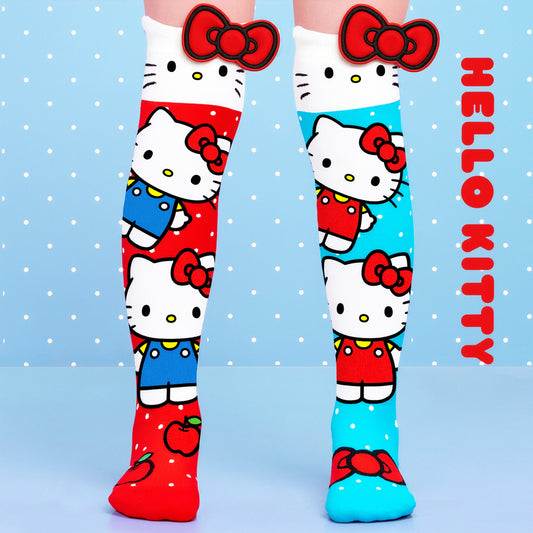 Hello Kitty knee high socks featuring colorful Sanrio character graphics and oversized 3D red bow details.