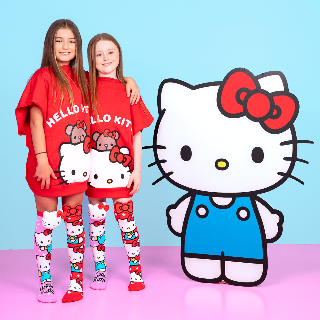Kids wearing Hello Kitty knee high socks with plush bows and character details