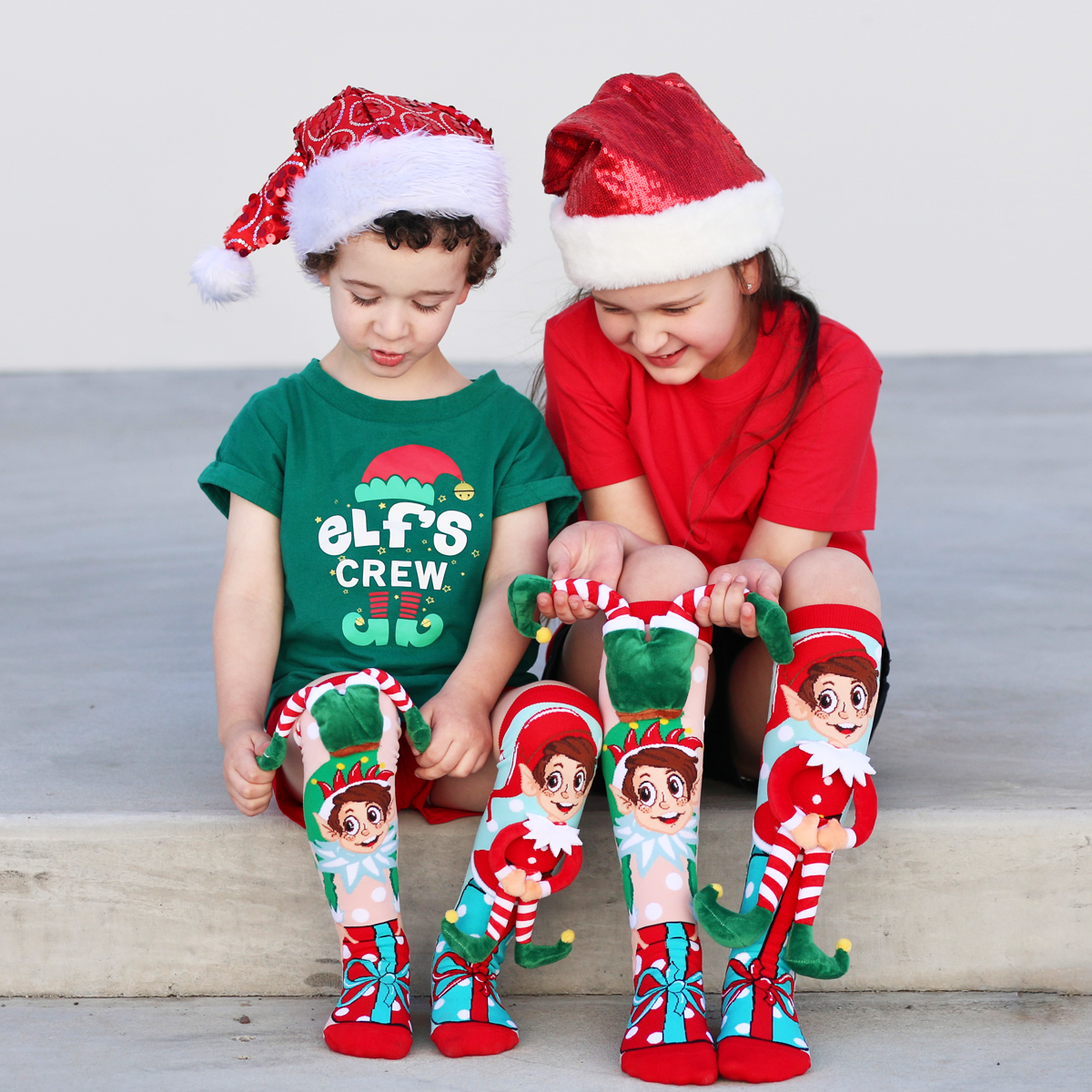 Holiday plush elf knee high socks with bright Christmas colors and playful seasonal graphics.