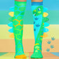 Kids dinosaur socks in green and blue with playful cartoon dinosaur graphics