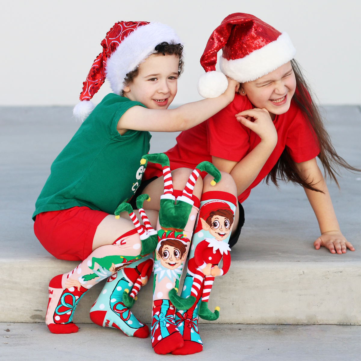 MADMIA Christmas elf socks featuring custom-made plush elves and cheerful holiday design.