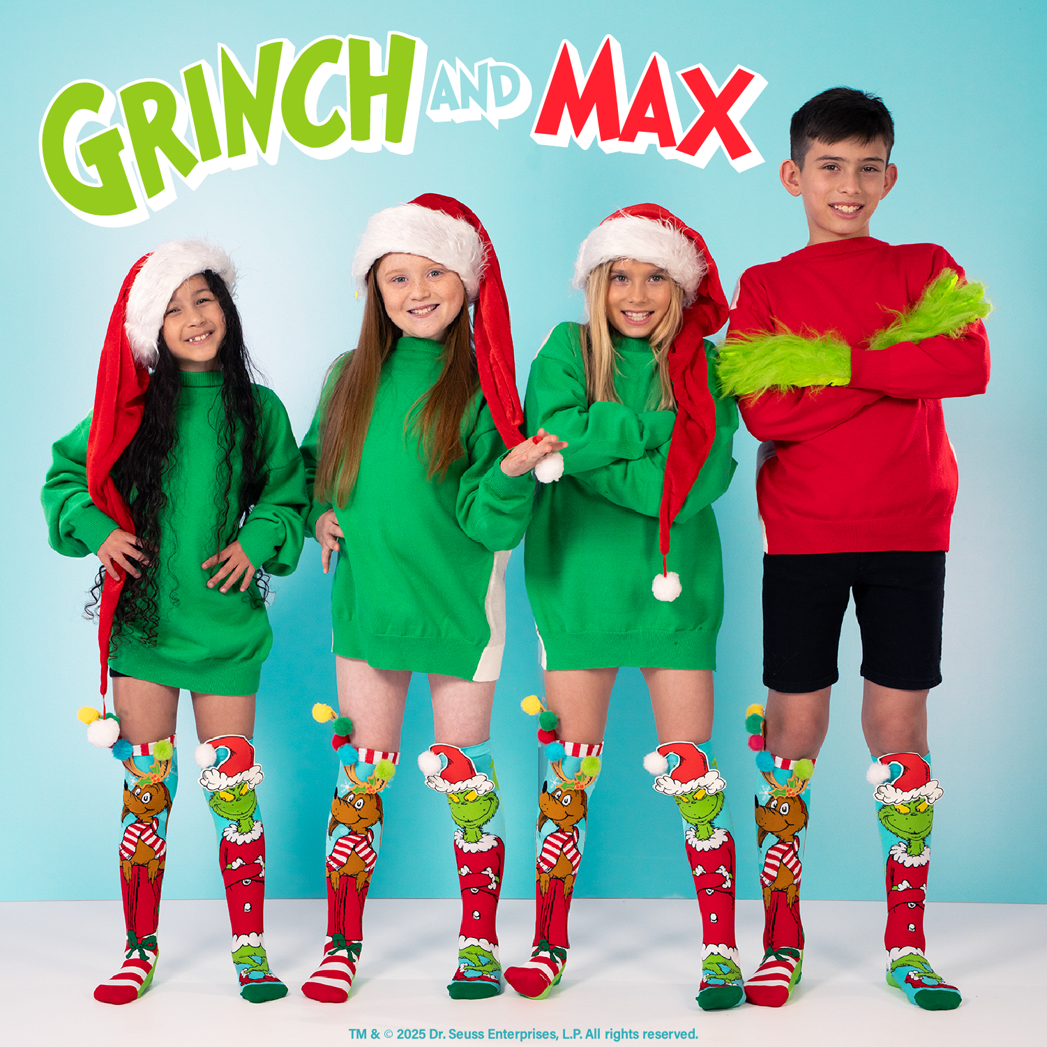 MADMIA Grinch socks featuring the Grinch in a Santa suit with a fluffy pom pom and colorful design.