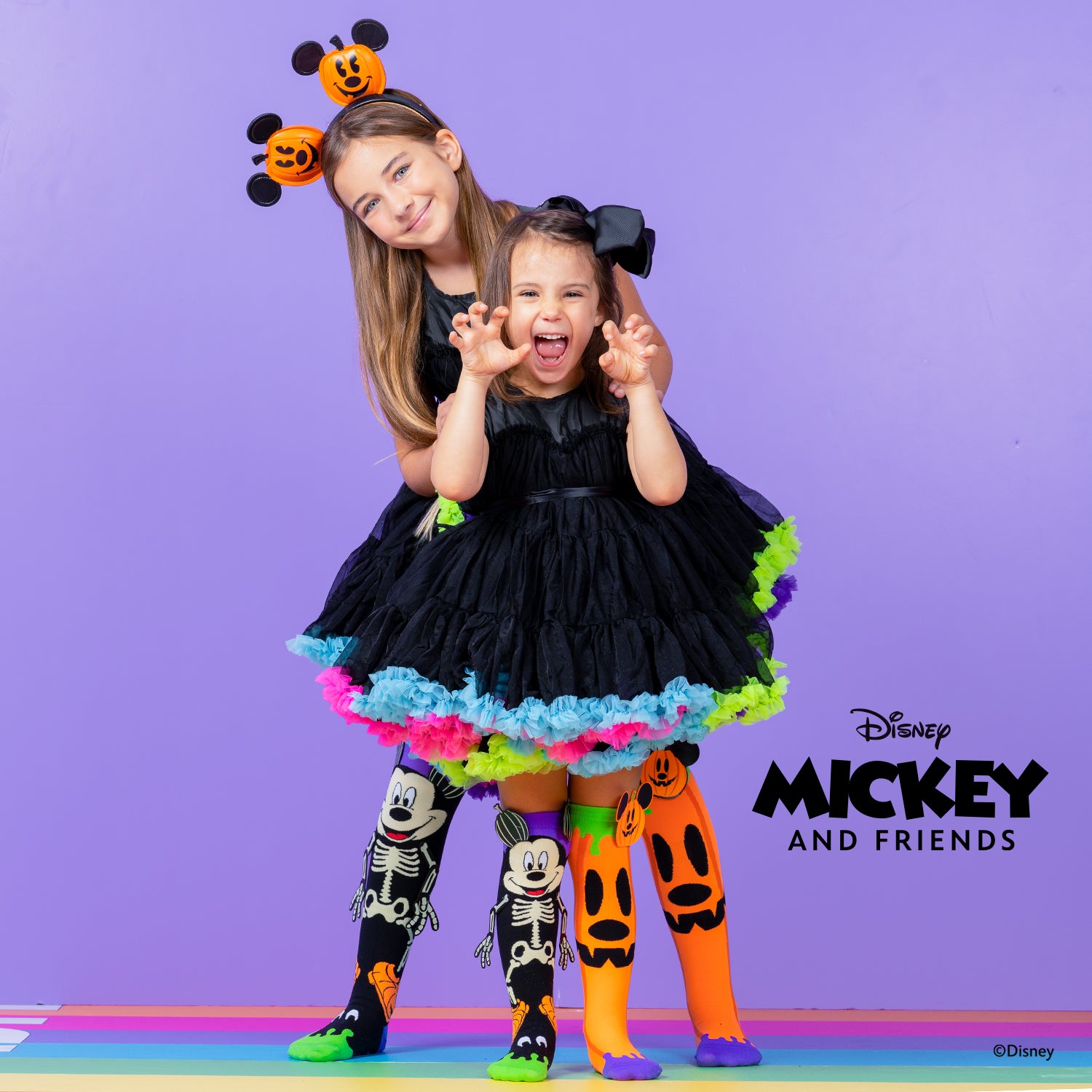 Mickey skeleton and pumpkin Halloween socks with bright colors and fun spooky character design.