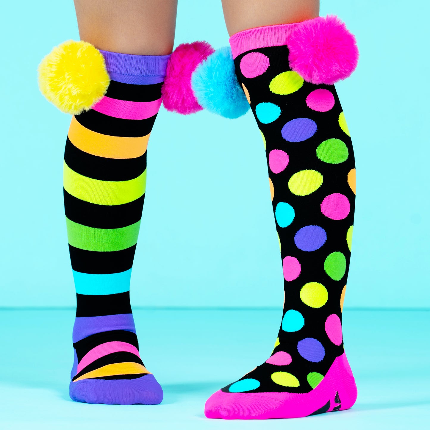 Pom pom knee high novelty socks for kids and adults featuring colorful design and soft playful pom poms.