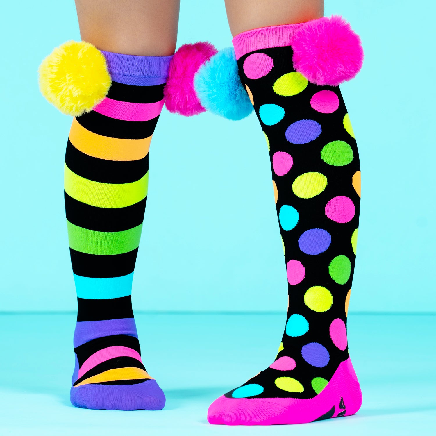 Pom pom knee high novelty socks for kids and adults featuring colorful design and soft playful pom poms.
