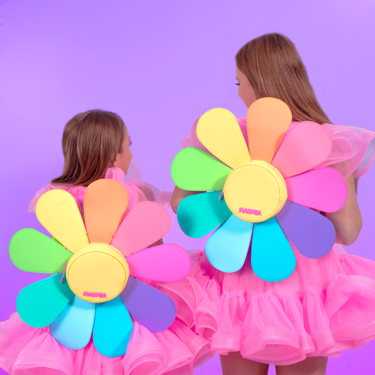 Girls wearing cute daisy shaped backpacks in bright rainbow colors