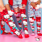 Sanrio Hello Kitty knee high socks featuring colorful character artwork with plush bows and 3D character details