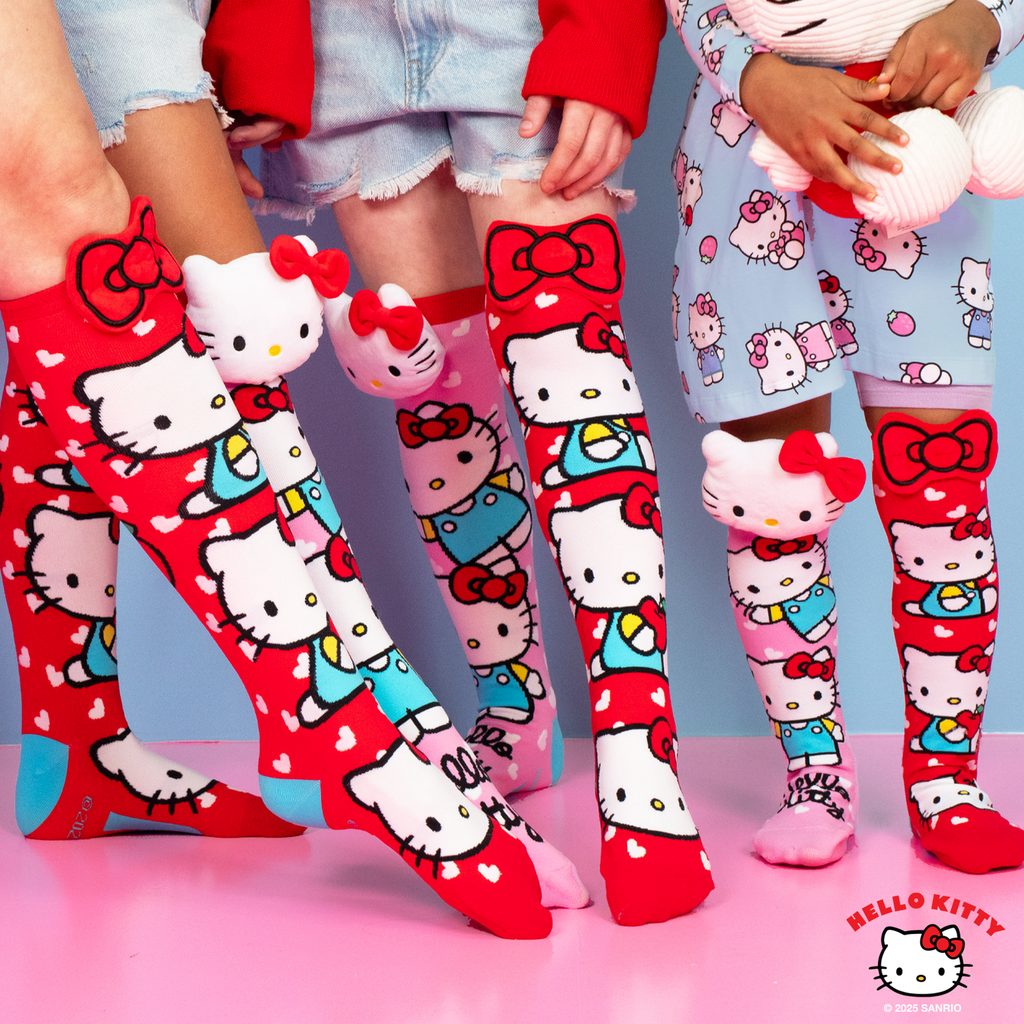 Sanrio Hello Kitty knee high socks featuring colorful character artwork with plush bows and 3D character details