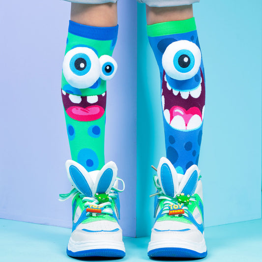 Silly Monster knee high socks featuring colorful design and custom-made plush 3D eyes.
