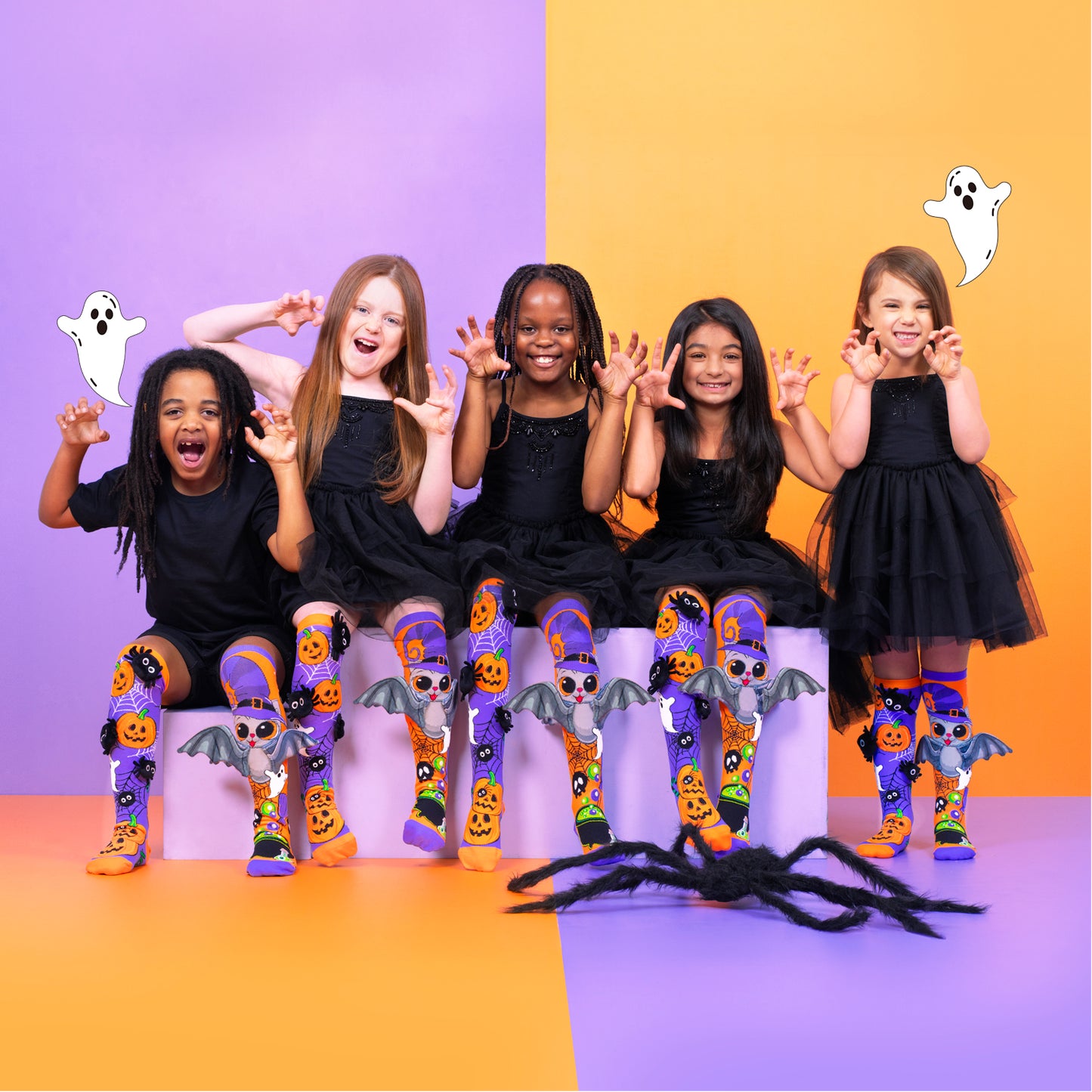 Spooky Halloween novelty socks with plush spider details and playful bat wing accents.