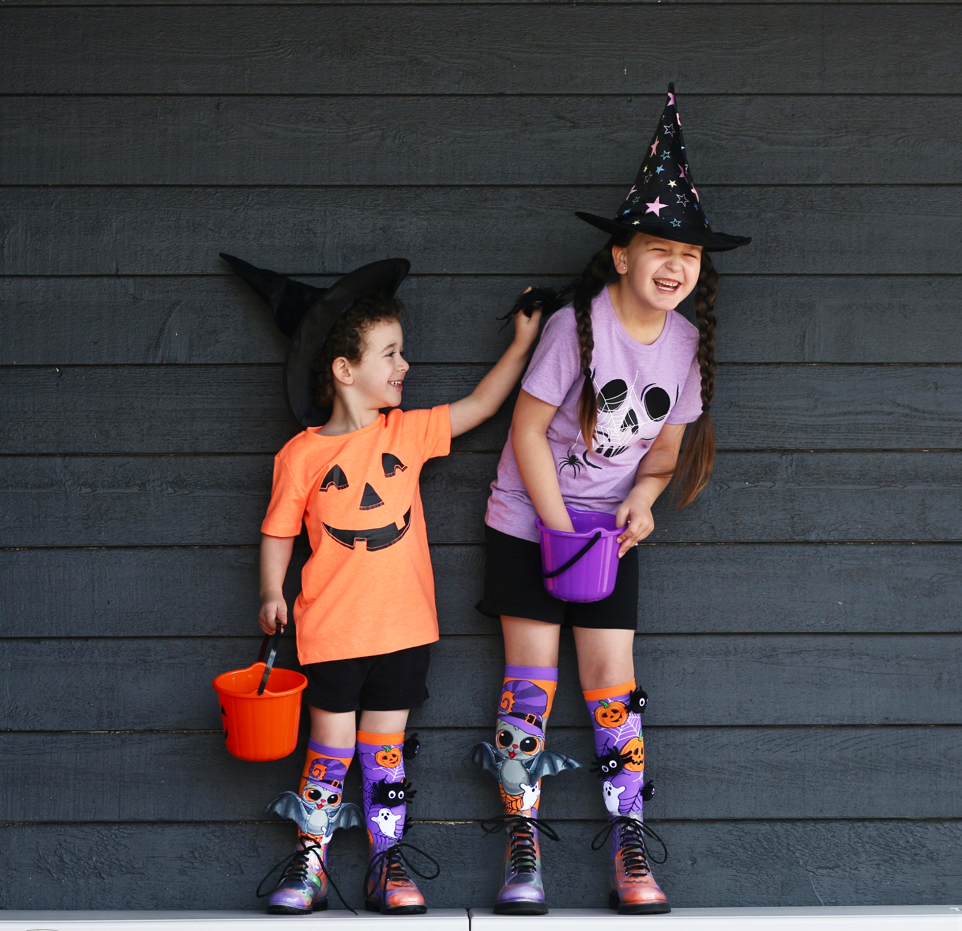Spooky Halloween socks featuring custom plush spiders, bat wings, and colorful trick-or-treat design.