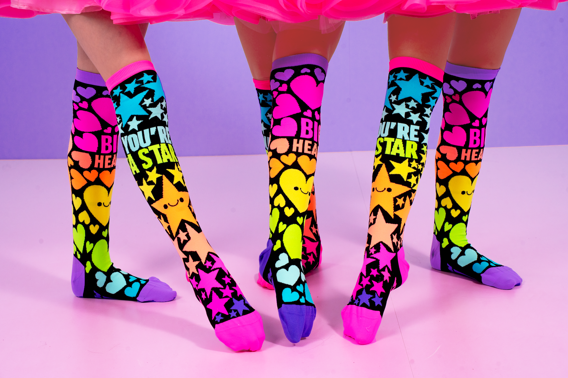 Star and heart knee high socks for kids featuring playful colorful graphics and bright neon details.