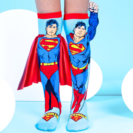 Superman knee high socks featuring a velvet cape, plush 3D arm, and iconic superhero design.