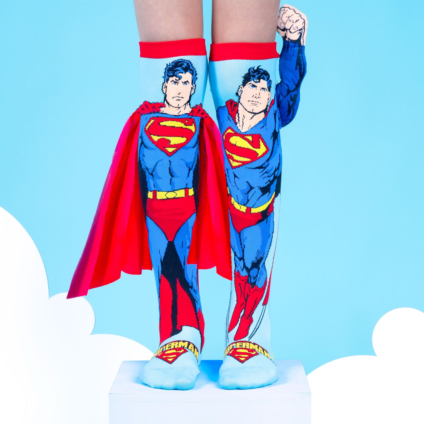 Superman novelty socks featuring attached plush arm detail and bright superhero colors.
