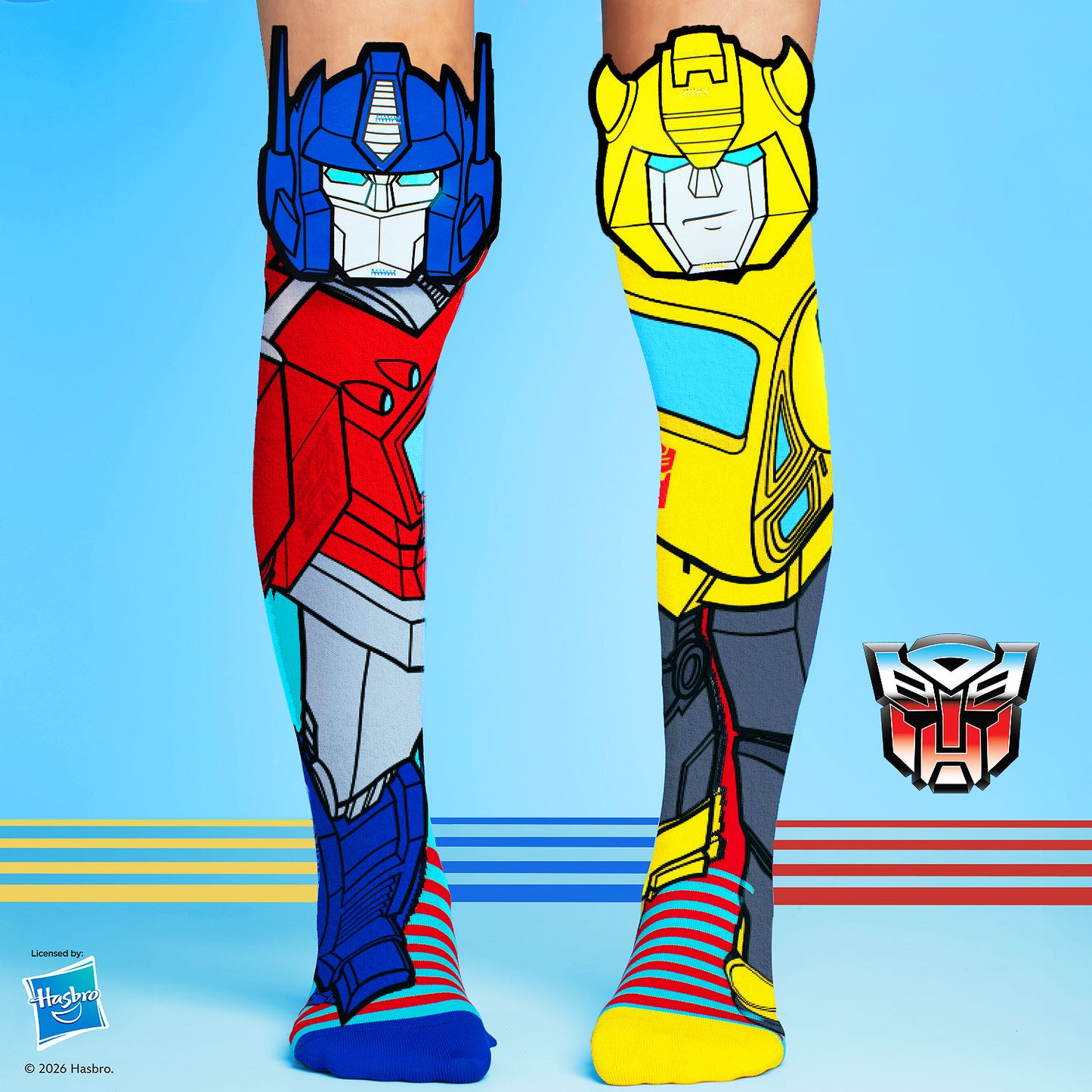 Transformers knee high socks featuring Optimus Prime and Bumblebee character graphics in bright red, blue, and yellow colors.