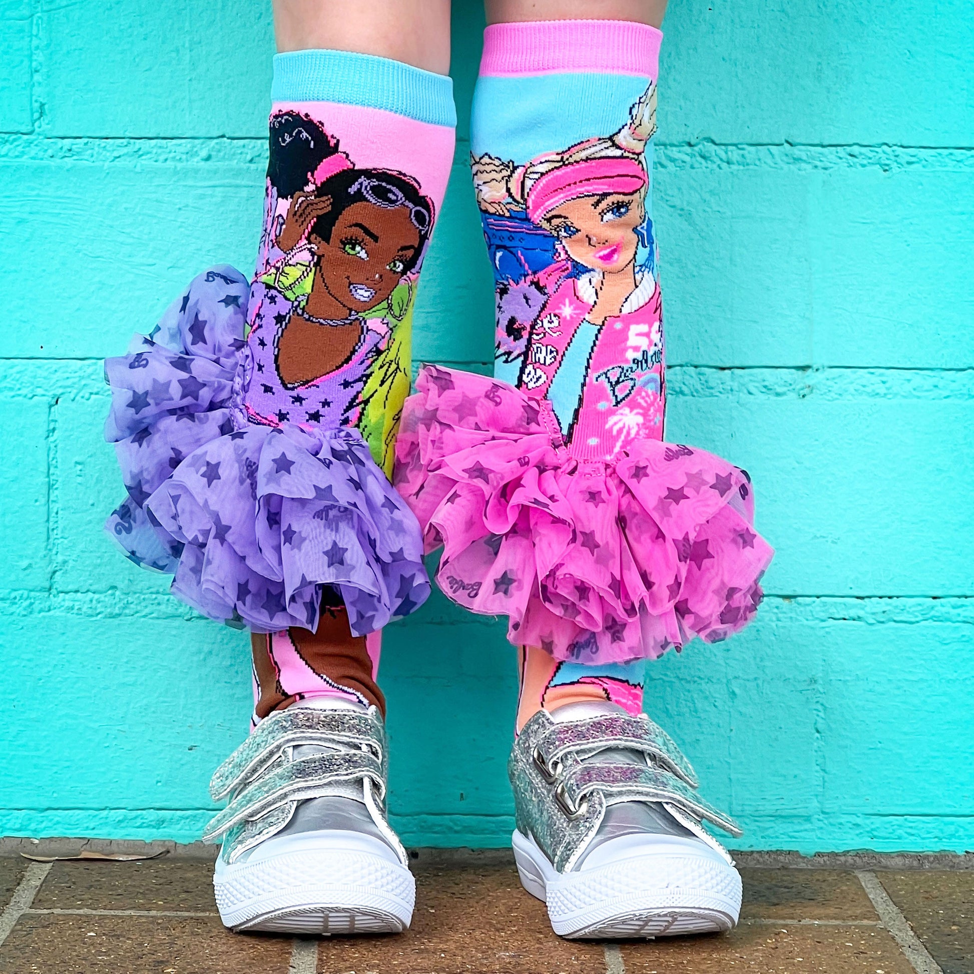 Fashionista Barbie socks featuring colorful patterns and attached 3D tutu skirts.